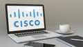 Laptop with Cisco Systems logo on the screen. Modern workplace conceptual editorial 3D rendering