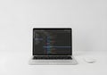 Laptop with Code Interface on Minimal White Desk Royalty Free Stock Photo