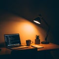 Laptop with code on screen, coffee, and plant on a desk at night Royalty Free Stock Photo