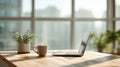 Laptop and coffee on sunlit office desk Royalty Free Stock Photo