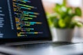 Laptop with colorful programming code on screen