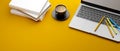 Laptop, coloured pencils, coffee cup and stack of books on yellow background, 3D rendering Royalty Free Stock Photo