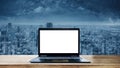 Laptop Computer Background. Computer laptop blank white screen on wooden desk and futuristic city background Royalty Free Stock Photo