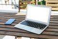 Laptop computer blank empty mock up screen on hotel balcony, working on vacation concept