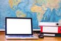 Laptop computer with blank empty screen on world map background Royalty Free Stock Photo