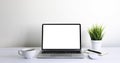 Laptop computer blank screen on white office desk table with coffee cup and notebook Royalty Free Stock Photo