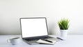 Laptop computer blank screen on white office desk table with coffee cup Royalty Free Stock Photo