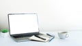 Laptop computer blank screen on white office desk table with coffee cup Royalty Free Stock Photo