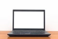 Laptop computer with blank white screen on the desk table. Royalty Free Stock Photo