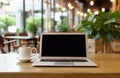 laptop computer blank white screen and mobile on table in cafe Royalty Free Stock Photo