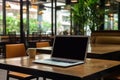 laptop computer blank white screen and mobile on table in cafe Royalty Free Stock Photo