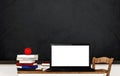 Laptop computer blank white screen, on wooden table in classroom Royalty Free Stock Photo