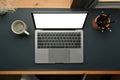 Laptop computer, cup of coffee and pencil holder on stylish workplace. Blank screen for your advertise text Royalty Free Stock Photo