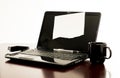 Laptop computer on desk with blank paper taped to the display screen