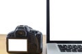 Laptop computer and digital camera have bank black screen of laptop and blank screen of back side digital camera on wood table Royalty Free Stock Photo