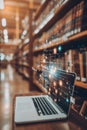 Laptop Computer Displaying Abstract Programming Code and Data Analysis Interface in Library Setting Royalty Free Stock Photo