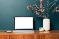 Laptop computer with empty blank mockup screen over emerald modern living room design. Home office, workplace Royalty Free Stock Photo