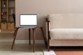 Laptop computer with empty blank mockup screen on vintage wooden table in modern living room. Home office, workplace Royalty Free Stock Photo