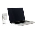 Laptop computer with a glass of water on a white background technology device Royalty Free Stock Photo