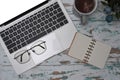 Laptop, glasses, notebook and Coffe cup on wooden desk. Royalty Free Stock Photo