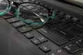 Laptop Computer Keyboard and Spectacles close-up Royalty Free Stock Photo