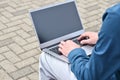 Laptop computer and man hands while working remotely on the computer outdoors. Royalty Free Stock Photo