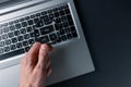 Laptop computer and man`s hand with magnifying glass on dark background, concept of search. Internet security conceptual image. Royalty Free Stock Photo