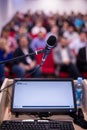 Laptop computer and microphone at podium