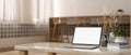A laptop computer mockup and decor on a marble coffee table in a cozy minimalist living room Royalty Free Stock Photo