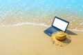 laptop or computer notebook on sea beach and wave - business travel background with empty white screen clipping path Royalty Free Stock Photo