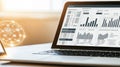 A laptop computer is open to a screen displaying a graph Royalty Free Stock Photo