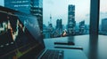 A laptop computer is open to a screen displaying a graph of stock prices Royalty Free Stock Photo