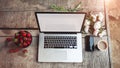 Workspace with girl`s hands, laptop computer, bouquet of peonies flowers, coffee, strawberries Royalty Free Stock Photo