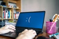 Laptop computer showing its screen with blue screen when it has a system error Royalty Free Stock Photo