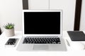 Laptop computer and smartphone with blank mock up screens are on top of white office desk table Royalty Free Stock Photo