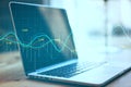 Laptop computer with stock chart and financial analytics Royalty Free Stock Photo