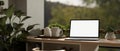 A laptop computer on a table on a beautiful and comfortable balcony with a greenery nature view Royalty Free Stock Photo