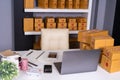 Laptop computer on table and parcel box ready for shipment to cu Royalty Free Stock Photo