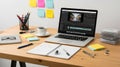 Laptop computer with video editing software on a desk. Royalty Free Stock Photo