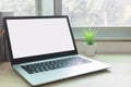 Laptop computer with white blank screen on desk in workspace and copy space concept Royalty Free Stock Photo