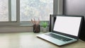 Laptop computer with white blank screen on desk in workspace and copy space concept Royalty Free Stock Photo