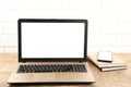 Laptop computer white blank screen with smartphone on work table. Front view Royalty Free Stock Photo