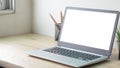 Laptop computer with white blank screen on wood desk. Workspace, workplace, desktop office concept Royalty Free Stock Photo