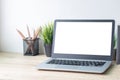 Laptop computer with white blank screen on wood desk. Workspace, workplace, desktop office concept Royalty Free Stock Photo