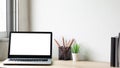 Laptop computer with white blank screen on wood desk. Workspace, workplace, desktop office concept Royalty Free Stock Photo