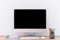 Laptop computer white blank screen on work table front view Royalty Free Stock Photo