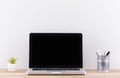 Laptop computer white blank screen on work table front view Royalty Free Stock Photo