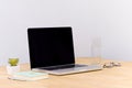Laptop computer white blank screen on work table front view Royalty Free Stock Photo