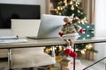 Laptop computer on wood table. Modern cozy home living room with Christmas decor Royalty Free Stock Photo