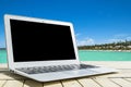 Laptop computer on wooden table. Top ocean view. Tropical island background. Open blank laptop computer empty space. Front view Royalty Free Stock Photo